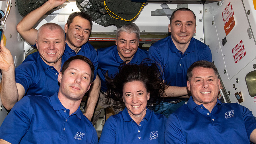 The seven-member Expedition 65 crew posed for a portrait aboard the space station on Oct. 4, 2021.