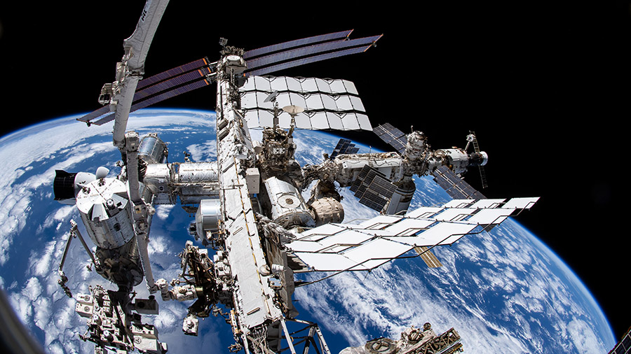 This view from NASA spacewalker Thomas Marshburn's camera points downward toward the space station with the Earth 265 miles below.