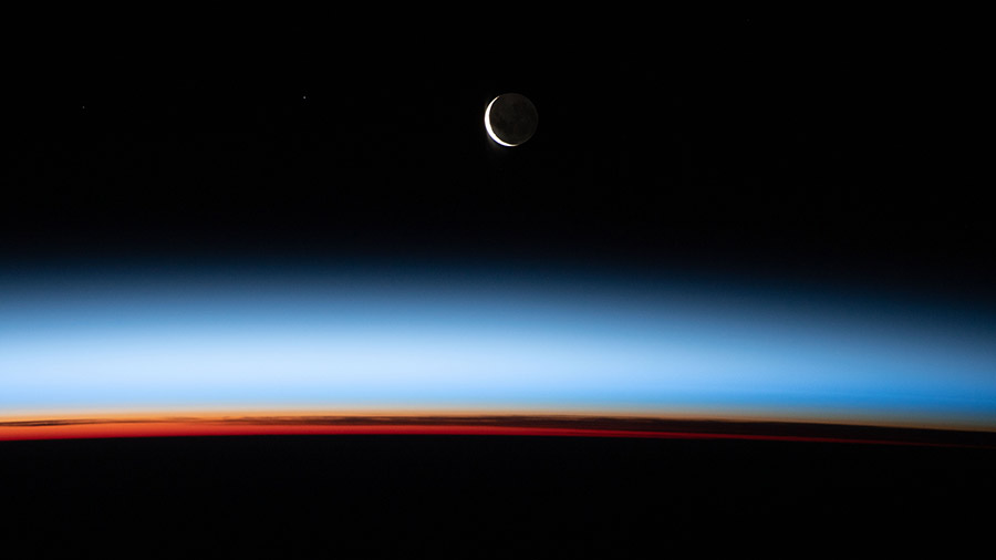 A waxing crescent Moon during is pictured from the station during an orbital sunset as it flew above the Pacific Ocean.