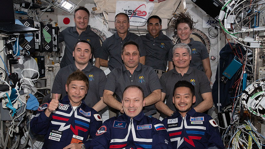 The three-person Soyuz MS-20 crew (front row) participates in a group portrait with the seven-member Expedition 66 crew.