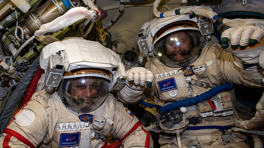 Cosmonauts (from left) Anton Shkaplerov and Pyotr Dubrov are pictured in their Russian Orlan spacesuits for a fit check and leak checks on Jan. 14.