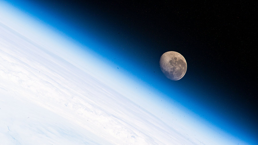 The waning gibbous Moon is pictured above the Earth's horizon from the International Space Station.