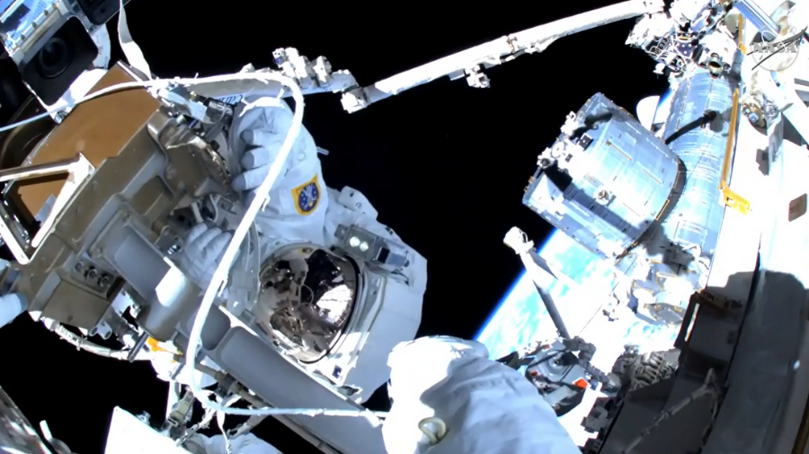 Astronauts Raja Chari and Matthias Maurer are pictured replacing an external high-definition camera during a 6-hour 54-minute spacewalk today. Credit: NASA TV.