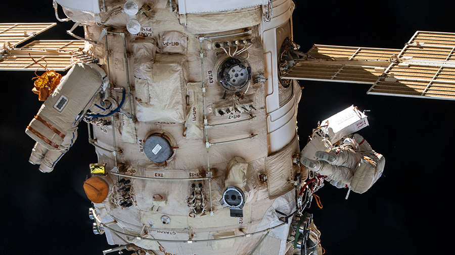 Roscosmos cosmonauts (from left) Denis Matveev and Oleg Artemyev are pictured during a spacewalk on April 18, 2022, to configure the European robotic arm.