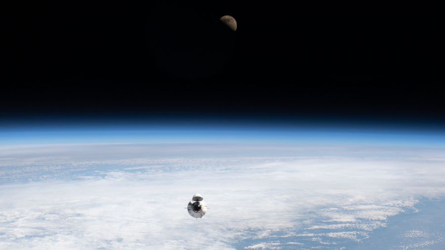 The SpaceX Dragon Endeavour carrying four Axiom Mission 1 astronauts approaches the International Space Station on April 9, 2022, with the first quarter Moon in the background.