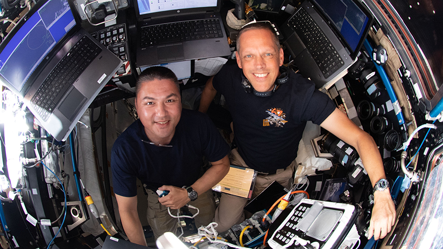 Astronauts (from left) Kjell Lindgren and Bob Hines are pictured monitoring the approach of Boeing's Starliner spacecraft on May 20, 2022.