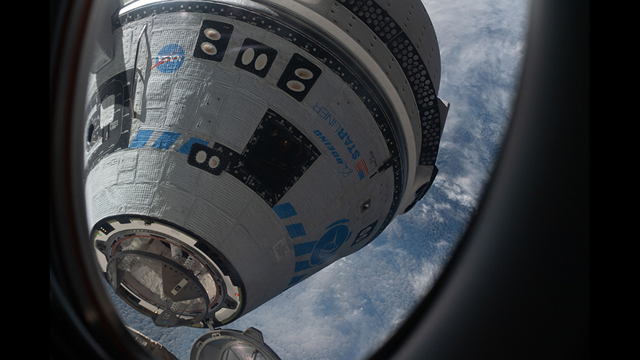 This view from a window on the SpaceX Dragon Freedom crew ship shows Boeing's Starliner crew ship moments away from docking to the station on May 20, 2022.