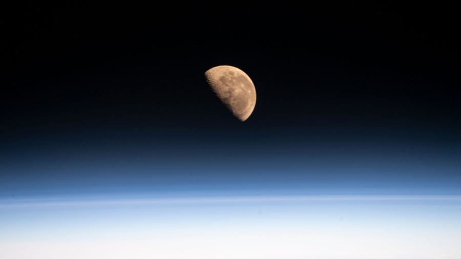 The Moon, pictured on May, 21, 2022, the day before going into its Last Quarter phase, is seen from the space station as it orbited 266 miles above the Pacific Ocean.