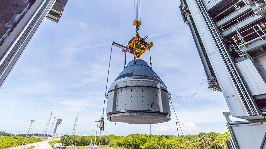 The Boeing Starliner spacecraft is lifted from the ground for placement atop the Atlas-V rocket ahead of its launch to the space station. Credit: United Launch Alliance