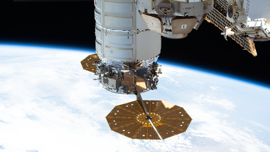 The Cygnus space freighter from Northrop Grumman, with its prominent cymbal-shaped solar arrays, is pictured attached to the space station.