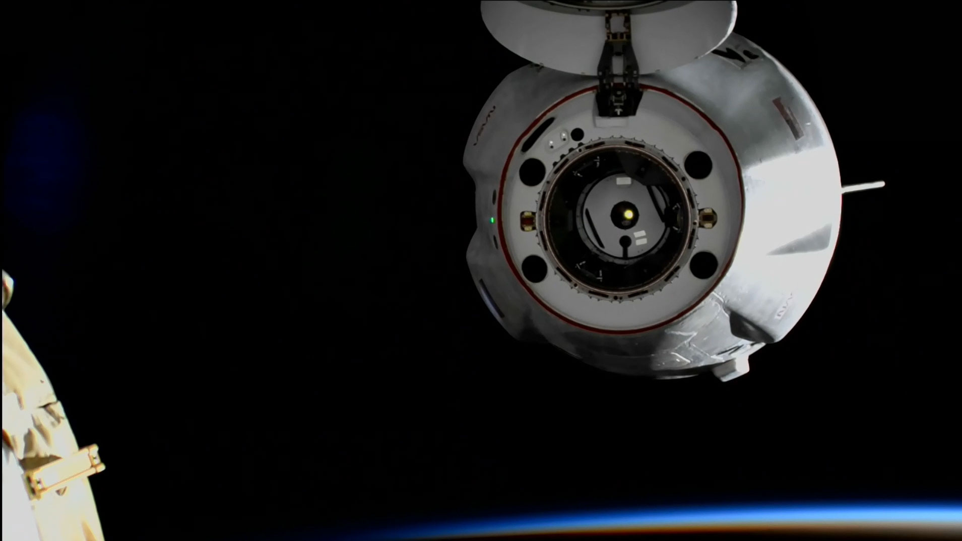 The SpaceX Dragon cargo craft backs away from the space station moments after undocking from the Harmony module's forward port during an orbital sunrise. Credit: NASA TV