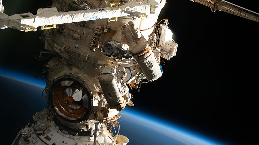 (From bottom to top) Spacewalkers Samantha Cristoforetti and Oleg Artemyev are pictured during a spacewalk to outfit the European robotic arm on July 21, 2022.