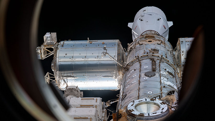 The SpaceX Dragon resupply ship (at top) is pictured docked to the Harmony module's forward port on the International Space Station.