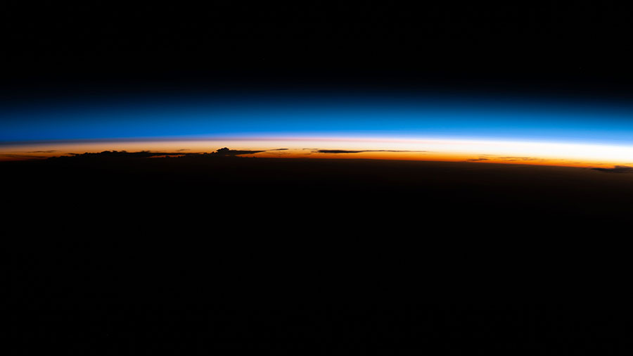 An orbital sunrise illuminate's Earth's atmosphere silhouetting the cloud tops as the space station soared 264 miles above South America.