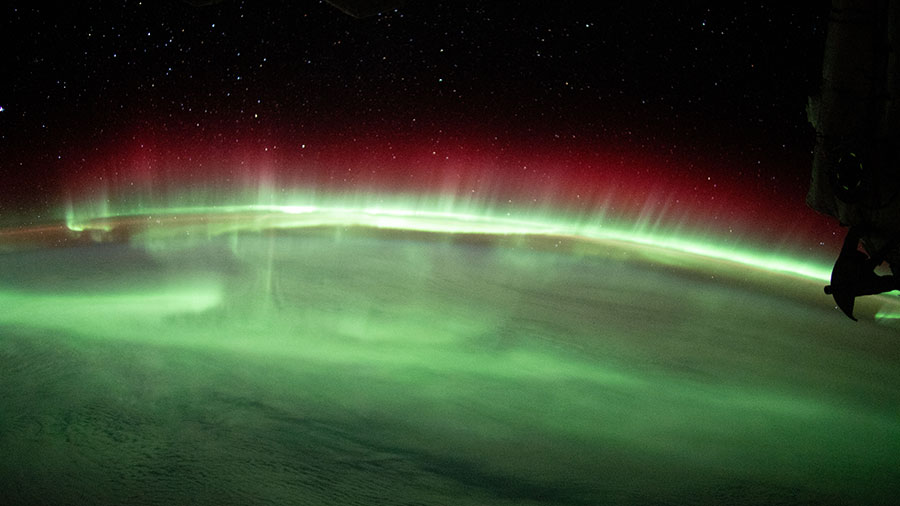 A brilliant aurora streams above Earth's horizon in this photograph from the space station as it orbited 270 miles above the Indian Ocean.