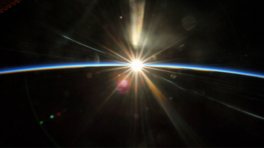 The sun's rays begin to illuminate the Earth's atmosphere as the International Space Station flew into an orbital sunrise 261 miles above Texas on July 16, 2022.