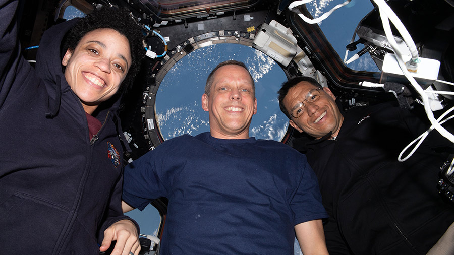 NASA astronauts (from left) Jessica Watkins, Bob Hines, and Frank Rubio pose for a portrait together inside the cupola, the International Space Station's 