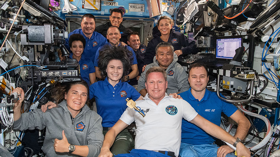 The 11 crew members who lived aboard the station together for eight days pose for a portrait on Oct. 12, 2022.