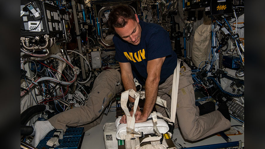 NASA astronaut Josh Cassada practices cardiopulmonary resuscitation (CPR) during a medical emergency drill aboard the space station.