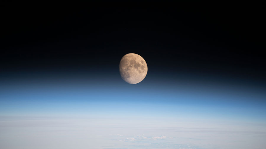 The Moon is pictured above Earth's horizon from the space station. The Orion vehicle on the Artemis I mission was almost 24,000 miles away from the Moon and approximately 222,200 miles from Earth at the time of this photograph.