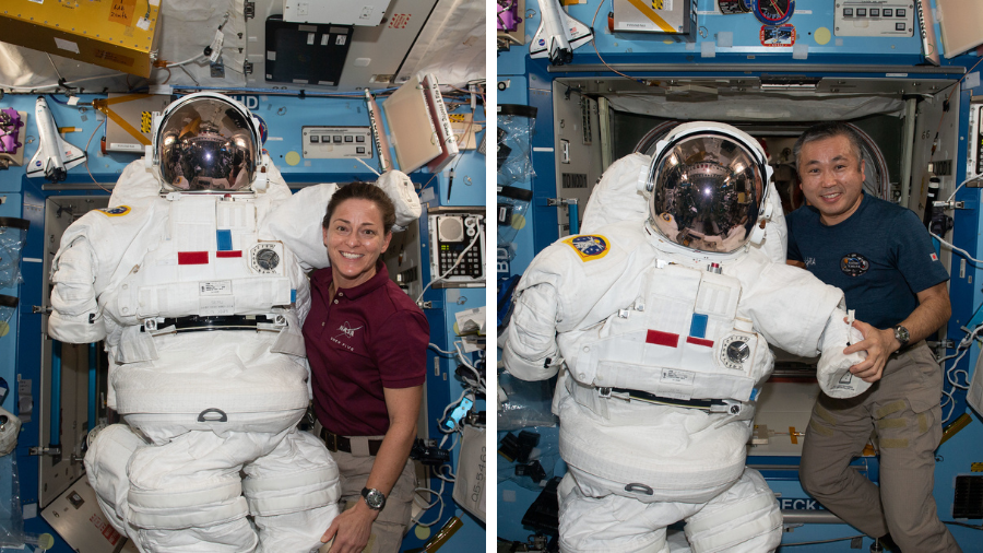 Expedition 68 Flight Engineers Nicole Mann and Koichi Wakata pose with an Extravehicular Mobility Unit (EMU), also known as a spacesuit on Dec. 28, 2022.