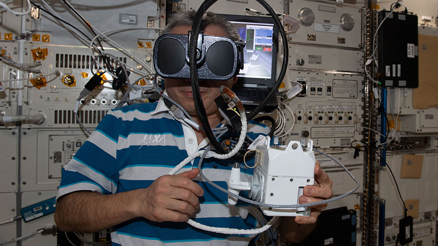 Astronaut Koichi Wakata wears virtual reality goggles aboard the space station while training for a spacewalk.