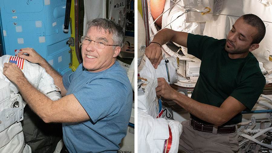 Expedition 69 Flight Engineers (from left) Stephen Bowen and Sultan Alneyadi prepare their spacesuits for an upcoming spacewalk to continue station power upgrades.