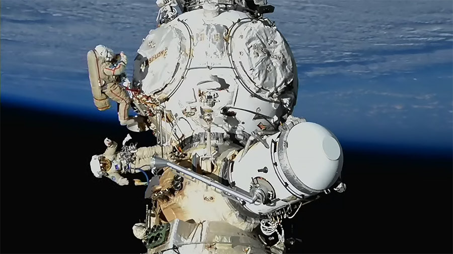 Spacewalkers Sergey Prokopyev and Dmitri Petelin work outside the Nauka science module to deploy a radiator and install gap spanners on the European robotic arm. Credit: NASA TV