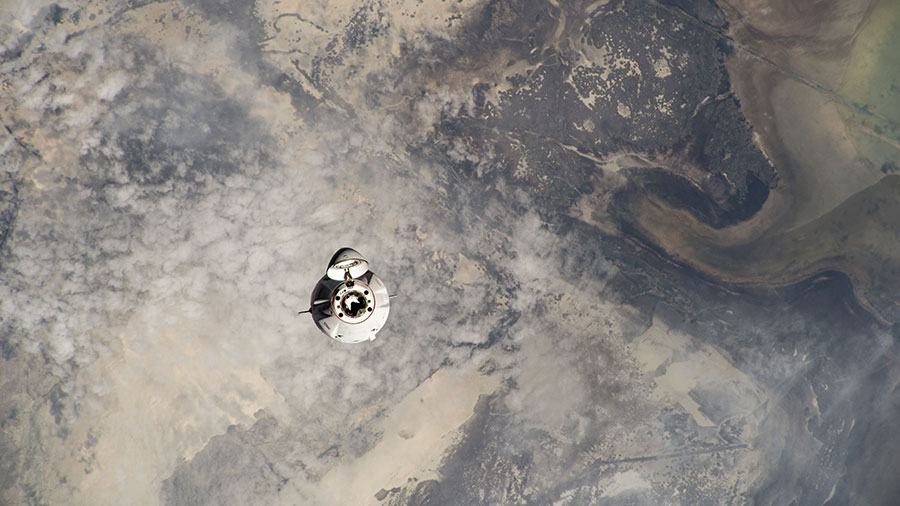 The SpaceX Dragon cargo spacecraft approaches the space station for an automated docking loaded with over 7,000 pounds of science experiments, station hardware, and crew supplies on June 9.