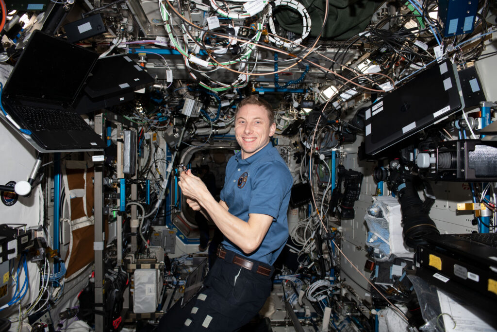 NASA astronaut and Expedition 69 Flight Engineer Woody Hoburg poses for a portrait during maintenance activities aboard the International Space Station.