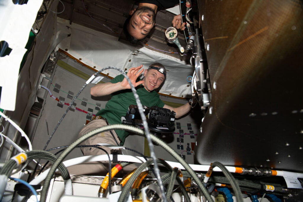 iss069e032151 (July 12, 2023) --- Expedition 69 Flight Engineers (from top) Sultan Alneyadi of UAE (United Arab Emirates) and Woody Hoburg of NASA are pictured inside the Tranquility module working on life support maintenance tasks aboard the International Space Station.