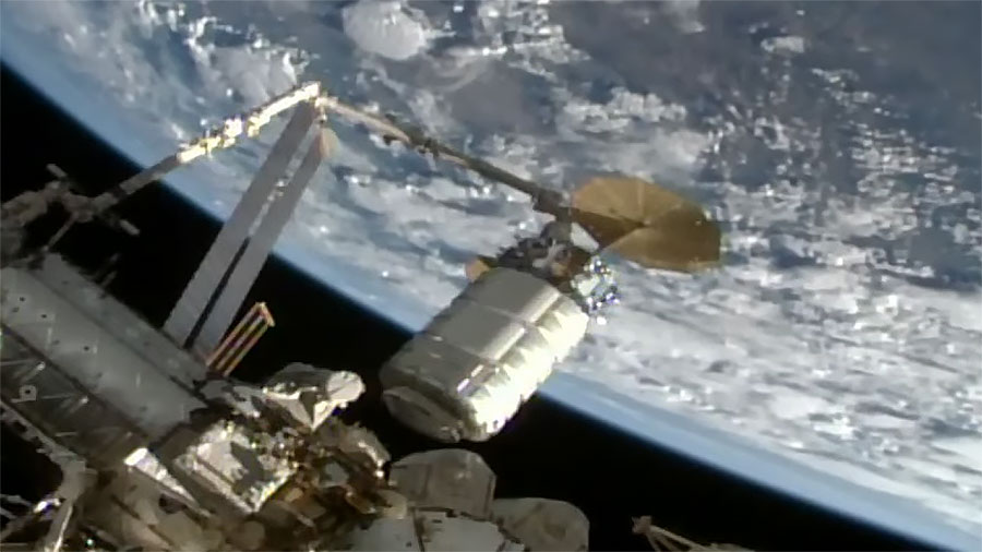 Northrop Grumman's Cygnus space freighter is guided to its installation point on the space station's Unity module by the Canadarm2 robotic arm. Credit: NASA TV