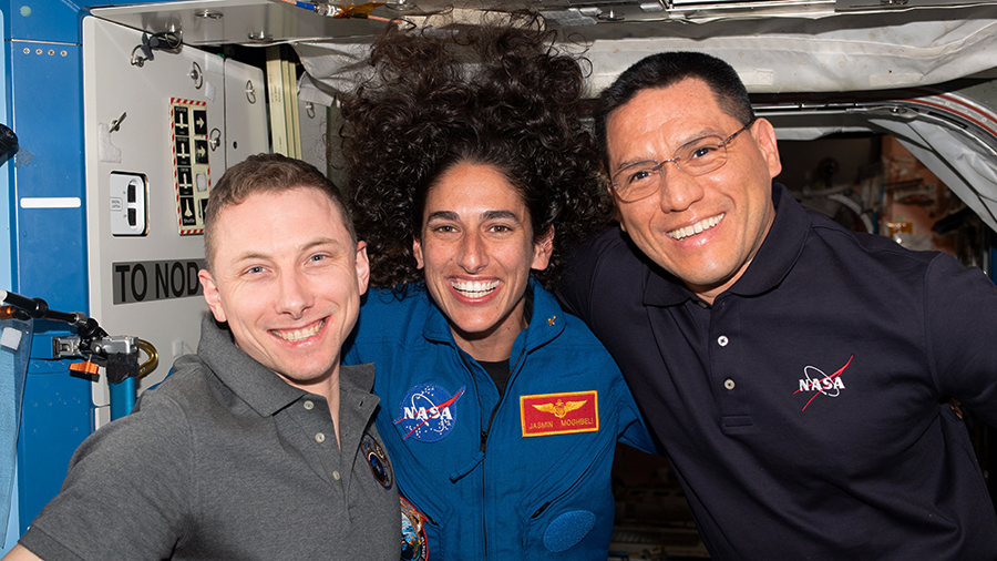 NASA astronauts Woody Hoburg, Jasmin Moghbeli, and Frank Rubio pose for a portrait aboard the International Space Station. The three crewmates were selected as part of NASA's 2017 class of astronauts.