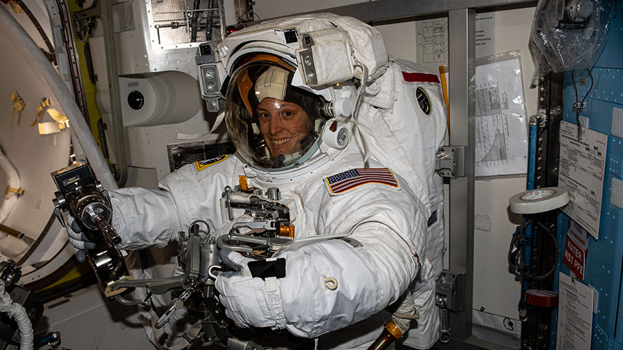 NASA astronaut Loral O'Hara is pictured trying on her spacesuit and testing its components aboard the International Space Station ahead of an upcoming spacewalk.