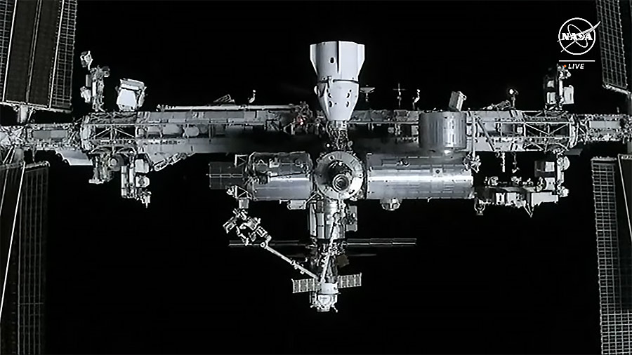 The station is viewed from the SpaceX Dragon cargo spacecraft. The SpaceX Dragon Endurance crew spacecraft is pictured at docked center top. Credit: NASA TV