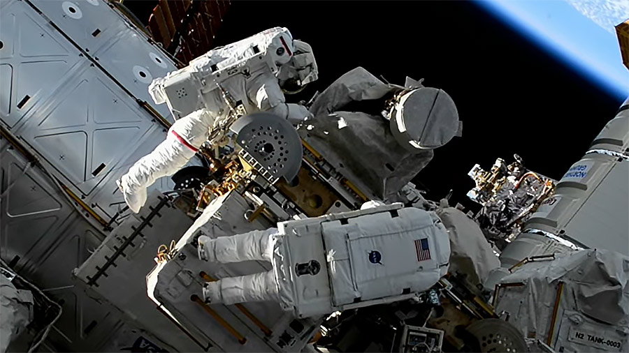 NASA astronauts Jasmin Moghbeli (top) and Loral O'Hara (bottom) team up during their first spacewalk for maintenance on the outside of the space station. Credit: NASA TV