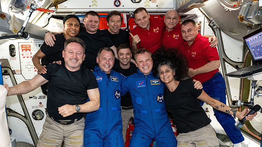 The 11-member Expedition 72 crew poses for a portrait inside Harmony module. In the front (from left) are, Butch Wilmore, Nick Hague, Matthew Dominick, Aleksandr Gorbunov, and Suni Williams. In the back are, Jeanette Epps, Aleksandr Grebenkin, Mike Barratt, Ivan Vagner, Don Pettit, and Alexey Ovchinin.