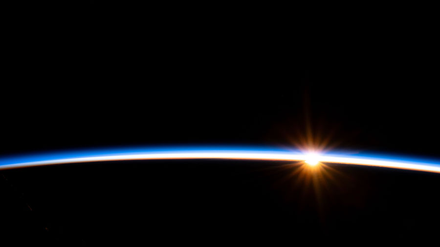 The first rays of an orbital sunrise illuminate Earth's atmosphere in this photograph from the space station as it orbited above the Pacific Ocean near Chile's Patagonia coast.