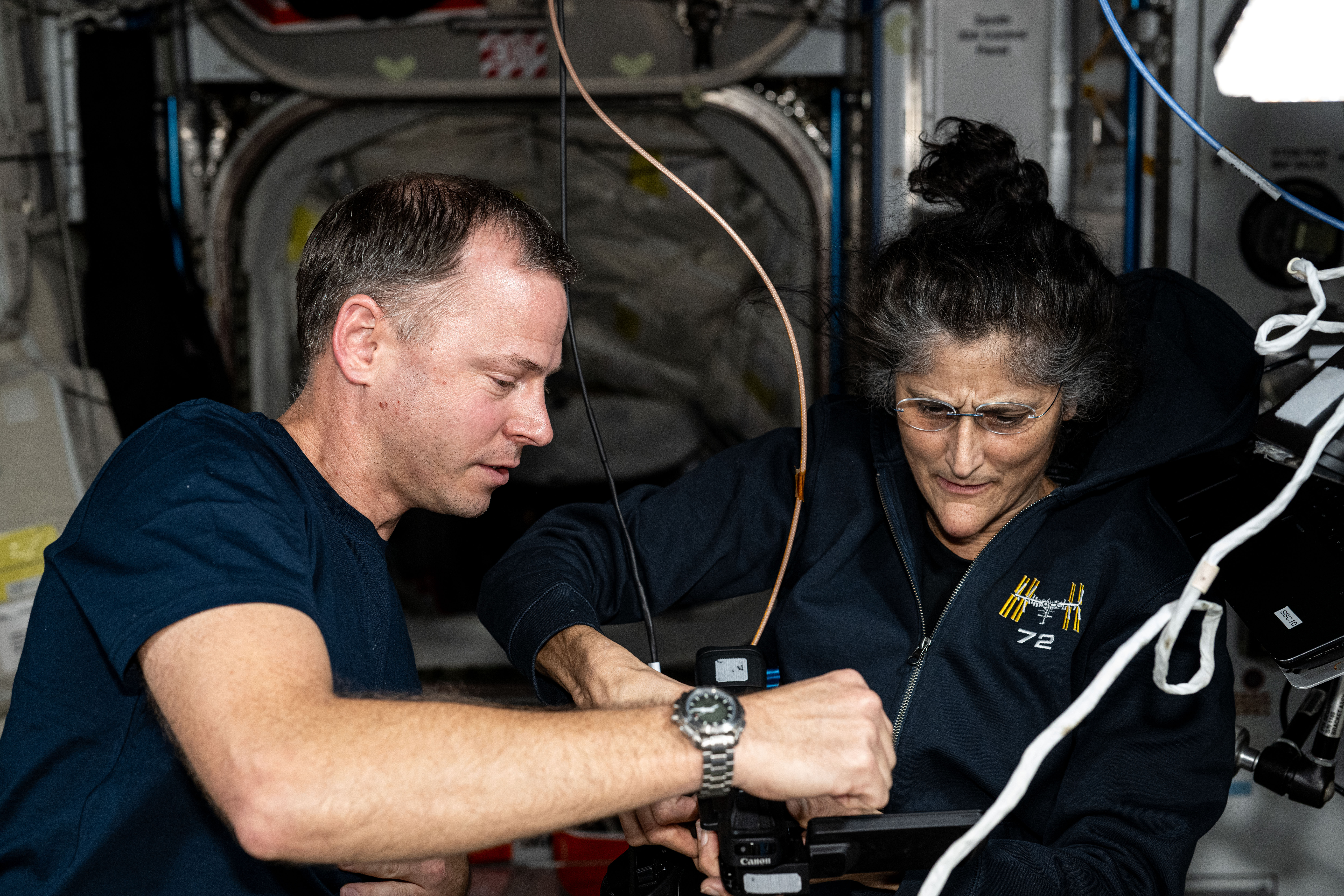 NASA astronauts Nick Hague and Suni Williams, Expedition 72 Flight Engineer and Commander respectively, discuss orbital lab maintenance procedures aboard the International Space Station.