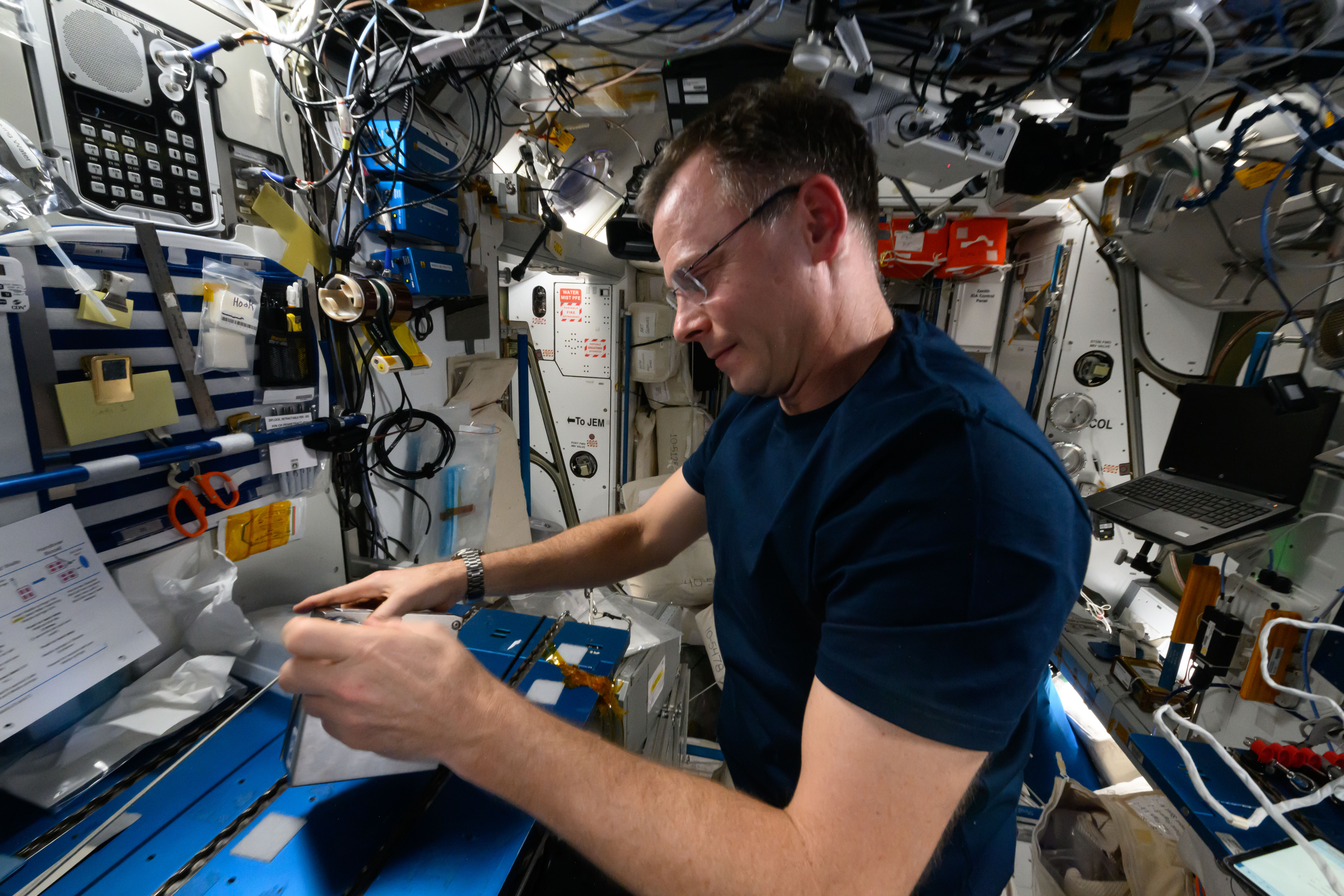 NASA astronaut and Expedition 72 Flight Engineer Nick Hague services samples of the Arthrospira C micro-algae for incubation and analysis.