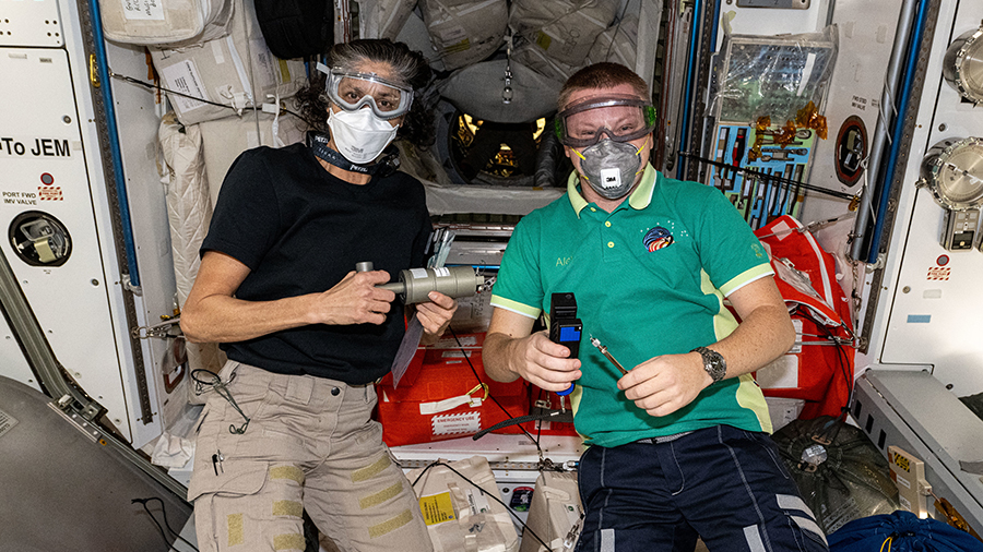 Expedition 72 crewmates Suni Williams of NASA and Aleksandr Gorbunov of Roscosmos wear personal protective equipment shortly after the hatches opened to the newly arrived SpaceX Dragon cargo spacecraft on Nov. 5, 2024. Photo credit: NASA