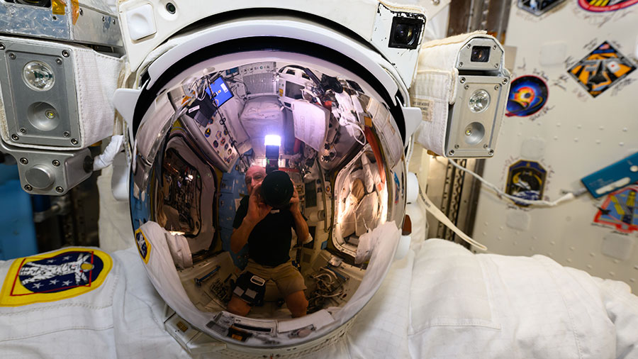 Astronaut Don Pettit took this photograph of a U.S. spacesuit helmet with his reflection prominent on the helmet's visor inside the International Space Station's Quest airlock.