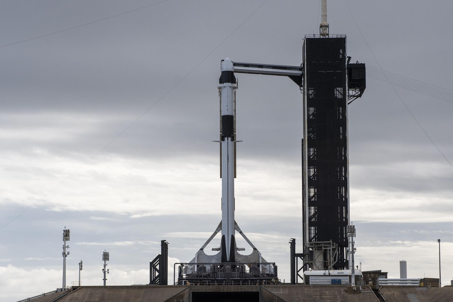 A SpaceX Falcon 9 rocket, with the company’s Dragon cargo spacecraft atop, is raised to a vertical position at NASA Kennedy Space Center’s Launch Complex 39A on Nov. 21, 2022, in preparation for the 26th commercial resupply services launch to the International Space Station. The mission will deliver new science investigations, supplies, and equipment to the crew aboard the space station, including the next pair of ISS Roll Out Solar Arrays (iROSAs).