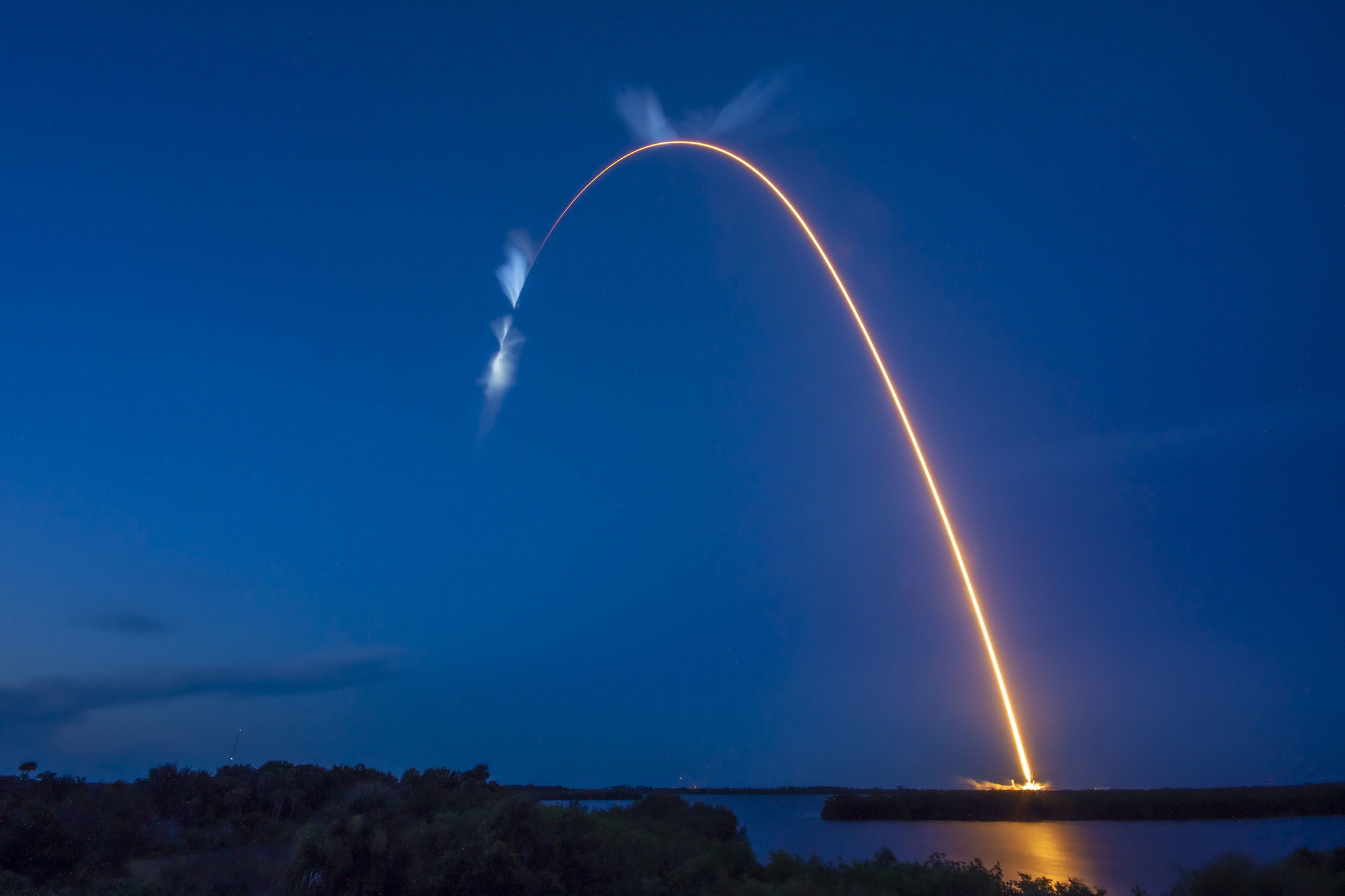 A bright white trail is in view after the SpaceX Falcon 9 rocket carrying the Dragon capsule lifts off from Launch Complex 39A at NASA’s Kennedy Space Center in Florida on July 14, 2022, on the company’s 25th Commercial Resupply Services mission for the agency to the International Space Station.