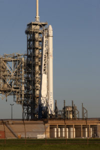 A SpaceX Falcon 9 rocket and Dragon spacecraft await liftoff from NASA Kennedy Space Center's Launch Complex 39A.