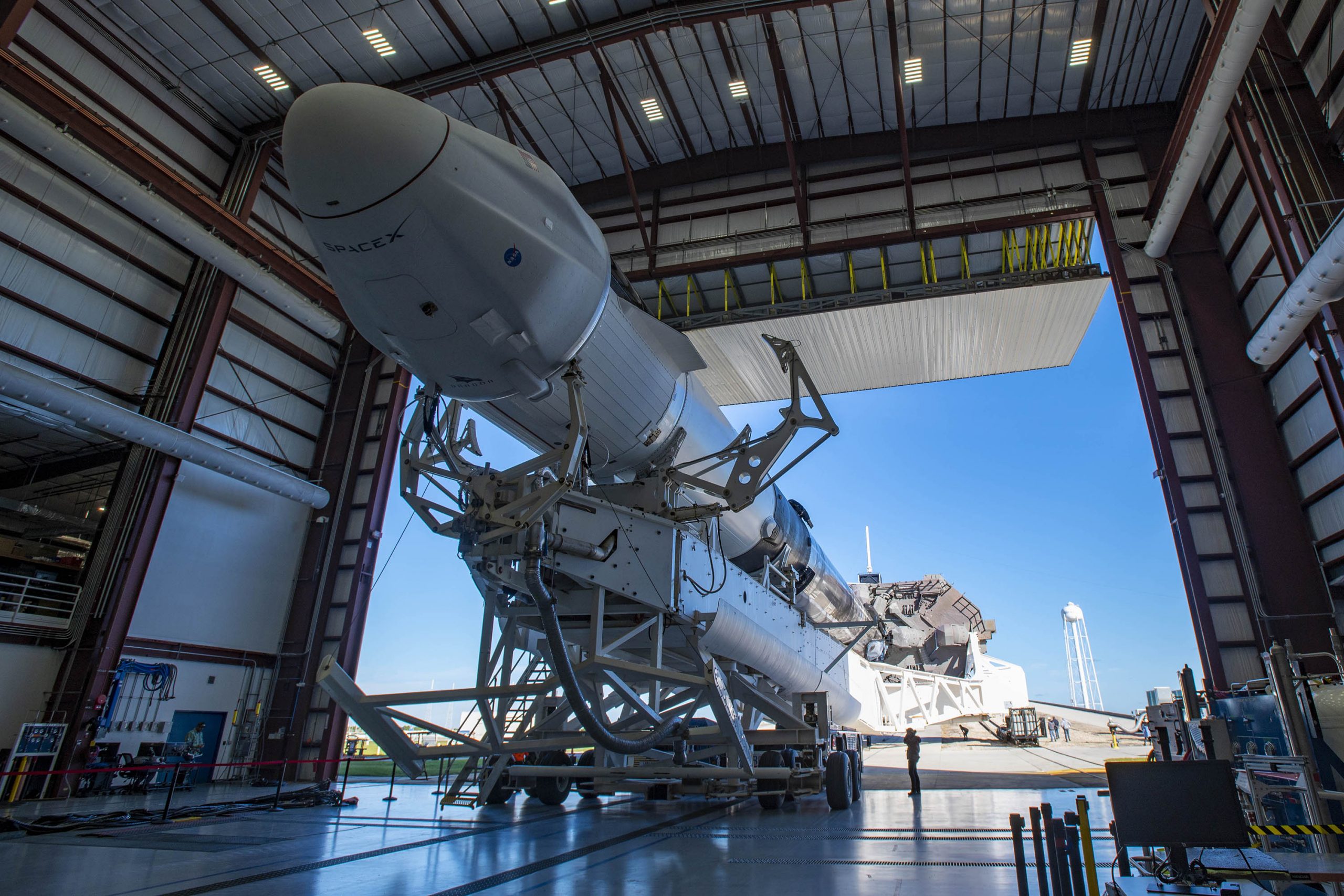 Falcon 9 and Cargo Dragon prepare to roll out to the launch pad for CRS-21.