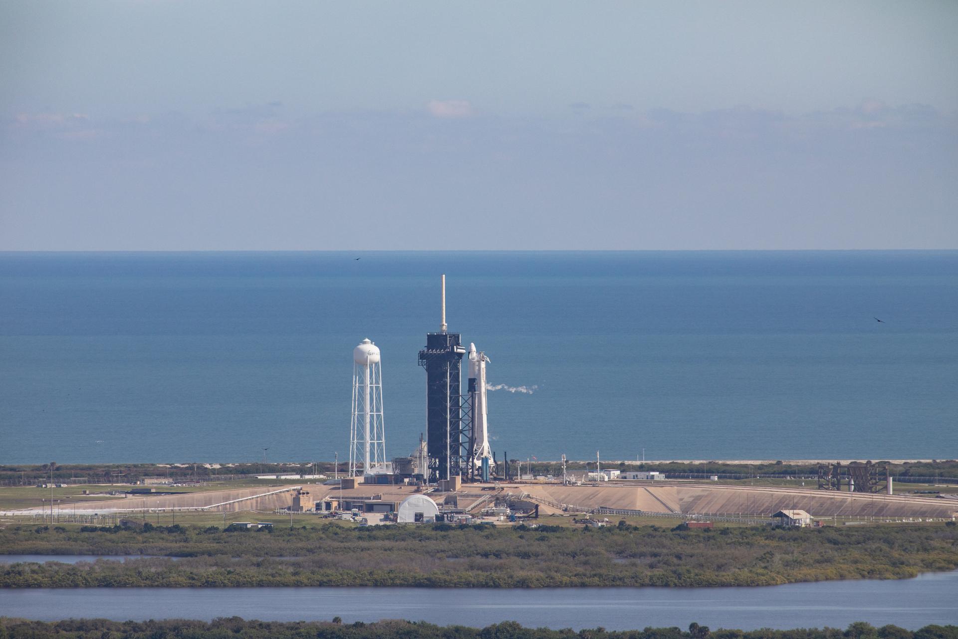 A SpaceX Falcon 9 rocket and uncrewed Cargo Dragon just before liftoff at Kennedy's Launch Complex 39A.