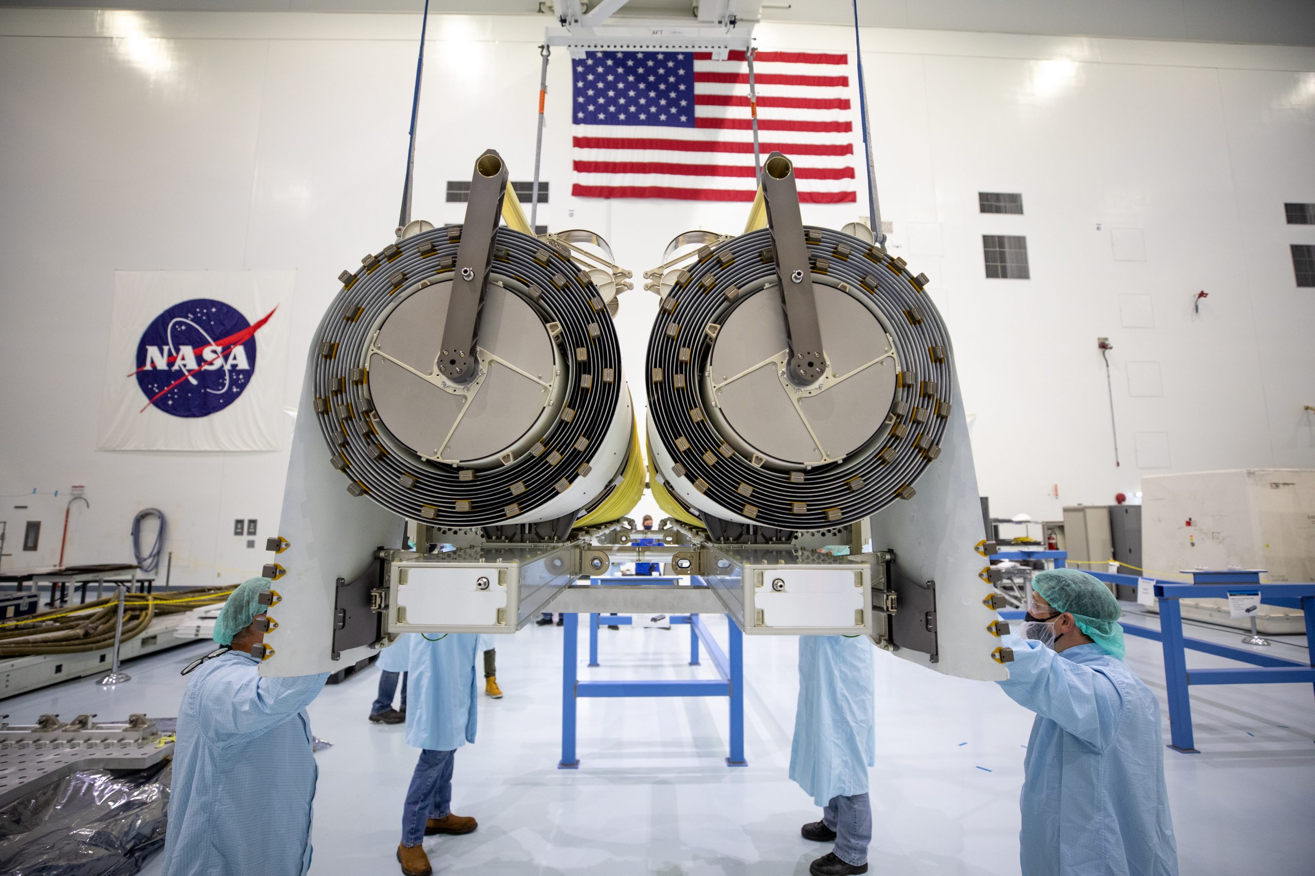 Image of engineers at NASA working with solar arrays in scientific setting