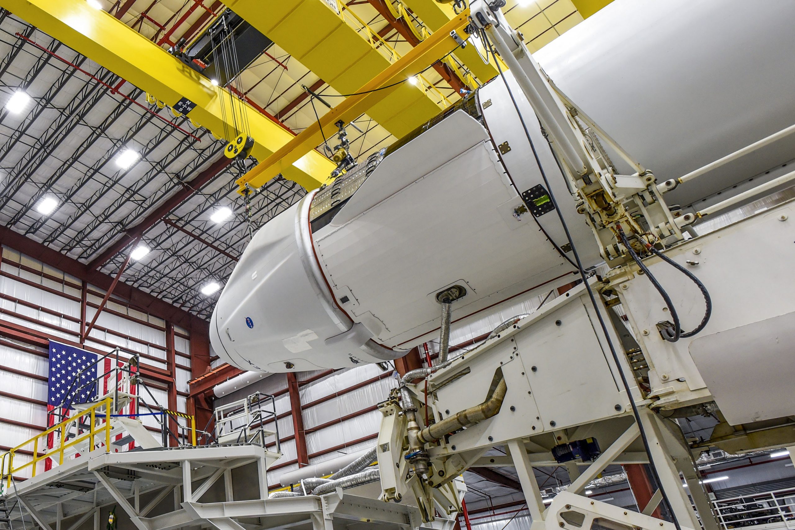 The Dragon spacecraft and Falcon 9 rocket are seen inside the hangar at Kennedy Space Center in Florida.