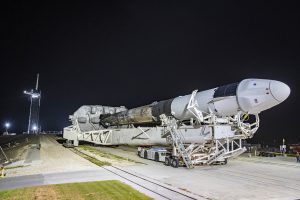 SpaceX Falcon 9 rocket and Cargo spacecraft rolling out to the launch pad